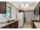 Galley kitchen with dark wood cabinets and appliances at 2695 S East Ave, Sarasota, FL 34239