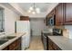 Galley kitchen with dark wood cabinets and appliances at 2695 S East Ave, Sarasota, FL 34239