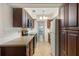 Galley kitchen with wood cabinets, built-in microwave, and ample counter space at 2695 S East Ave, Sarasota, FL 34239