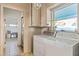 Laundry room with washer, dryer, and additional storage at 2695 S East Ave, Sarasota, FL 34239