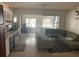 Open concept living area with kitchen, dining, and living spaces, leading to a sunlit enclosed patio at 2695 S East Ave, Sarasota, FL 34239