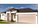 Well-designed modern single-story home with a two-car garage and inviting entrance at 11322 Zola Ave, Port Charlotte, FL 33981