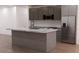 Modern kitchen with a large island, stainless steel appliances, and ample counter space at 11322 Zola Ave, Port Charlotte, FL 33981