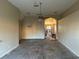 Open living room with ceiling fan and archway at 19034 Narimore Dr, Land O Lakes, FL 34638