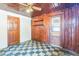 Laundry area with wood paneling, checkerboard floor, and exterior access at 4035 Fairfield S Ave, St Petersburg, FL 33711