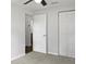 Bedroom with carpet, double closet and door to hallway at 10009 Connecticut St, Gibsonton, FL 33534