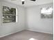 Bedroom featuring neutral carpet and large window at 10009 Connecticut St, Gibsonton, FL 33534