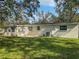 Back of house with a large yard and covered patio area at 10009 Connecticut St, Gibsonton, FL 33534