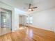 Light and airy bedroom featuring hardwood floors and mirrored closet doors at 11224 Villas On The Green Dr # 77, Riverview, FL 33579