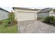 Side view of a house with a paved driveway and landscaping at 117 Whiteland Bnd, Nokomis, FL 34275