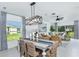 Bright dining area with a farmhouse table and access to kitchen at 5807 Laurelcrest Gln, Palmetto, FL 34221