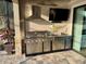 Stainless steel outdoor kitchen with grill and TV at 1831 Cameron Ct, New Port Richey, FL 34655