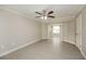 Large bedroom with double doors to office and ceiling fan at 23104 Newcun Ave, Punta Gorda, FL 33980