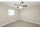 Well-lit bedroom with ceiling fan and laminate floors at 23104 Newcun Ave, Punta Gorda, FL 33980