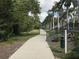 Scenic walking path with lush landscaping and palm trees at 3010 Grand Bay Blvd # 472, Longboat Key, FL 34228