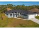 New construction home with gray exterior and paved driveway at 3505 Brownwood Ter, North Port, FL 34286