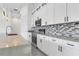 Modern kitchen with white cabinets and a stylish backsplash at 3505 Brownwood Ter, North Port, FL 34286