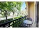 Small balcony with table and chairs overlooking lush landscaping at 875 Normandy Trace Rd, Tampa, FL 33602