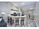 Modern kitchen with white cabinets, a breakfast bar, and stainless steel appliances at 875 Normandy Trace Rd, Tampa, FL 33602