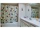 Updated bathroom with a shower/tub combo, vanity and decorative shower curtain at 6809 9Th W Ave # 0, Bradenton, FL 34209