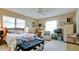 Spacious bedroom with a queen-size bed, ample natural light, and a ceiling fan at 6809 9Th W Ave # 0, Bradenton, FL 34209