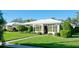 White single story home with a sunroom and well-manicured lawn at 6809 9Th W Ave # 0, Bradenton, FL 34209