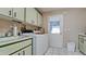 Bright laundry room with washer, dryer, and cabinets at 6809 9Th W Ave # 0, Bradenton, FL 34209