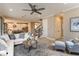 Spacious living room with L-shaped sofa and view of kitchen at 7044 Foxboro Way, Nokomis, FL 34275