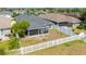 Aerial view of house with backyard and white fence at 14308 Edinburgh Moor Dr, Wimauma, FL 33598