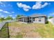 Backyard with screened lanai and lake view at 14308 Edinburgh Moor Dr, Wimauma, FL 33598