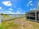 Backyard with lake view, white fence, and hot tub at 14308 Edinburgh Moor Dr, Wimauma, FL 33598