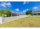 Spacious backyard with a white picket fence at 14308 Edinburgh Moor Dr, Wimauma, FL 33598
