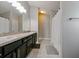 Bathroom with double vanity, granite countertop, and shower at 14308 Edinburgh Moor Dr, Wimauma, FL 33598