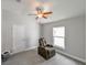 Bedroom with a recliner, ceiling fan, and window at 14308 Edinburgh Moor Dr, Wimauma, FL 33598