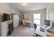 Home office or bedroom with desk, TV, and ample storage at 14308 Edinburgh Moor Dr, Wimauma, FL 33598