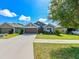 Charming single-story home with a well-maintained lawn and two-car garage at 14308 Edinburgh Moor Dr, Wimauma, FL 33598