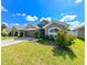 Single-story home with a well-manicured lawn and attached garage at 14308 Edinburgh Moor Dr, Wimauma, FL 33598
