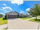Two-car garage and front yard landscaping at 14308 Edinburgh Moor Dr, Wimauma, FL 33598