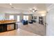 Open concept kitchen and living room with stainless steel appliances and neutral colors at 14308 Edinburgh Moor Dr, Wimauma, FL 33598