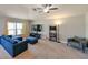 Spacious living room featuring a comfortable sectional sofa and large windows at 14308 Edinburgh Moor Dr, Wimauma, FL 33598