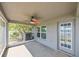 Screened lanai with ceiling fan and backyard access at 14308 Edinburgh Moor Dr, Wimauma, FL 33598