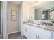 Bathroom with double vanity, granite countertops, and walk-in shower at 32094 Eastern Redbud Br, San Antonio, FL 33576