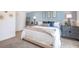 Main bedroom with light blue accent wall and plush bedding at 32094 Eastern Redbud Br, San Antonio, FL 33576