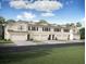 Front view of townhouses with attached garages and landscaping at 32094 Eastern Redbud Br, San Antonio, FL 33576