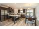 Modern kitchen with island, stainless steel appliances, and breakfast nook at 32094 Eastern Redbud Br, San Antonio, FL 33576