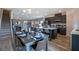 Open kitchen with island and breakfast bar, flows into dining and living areas at 32094 Eastern Redbud Br, San Antonio, FL 33576