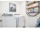 Laundry room with washer, dryer, and shelving at 32094 Eastern Redbud Br, San Antonio, FL 33576