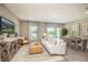 Open living space with white sofa, dining area, and lake view at 32094 Eastern Redbud Br, San Antonio, FL 33576