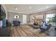 Bright living room featuring wood-look floors and comfortable seating at 32094 Eastern Redbud Br, San Antonio, FL 33576