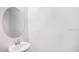 Clean powder room with a vanity and oval mirror at 32094 Eastern Redbud Br, San Antonio, FL 33576